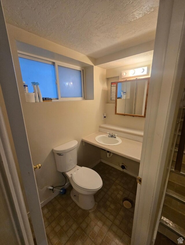 777 Simoron Dr, Ogden, UT 84404 - half bath with toilet, vanity, and a textured ceiling