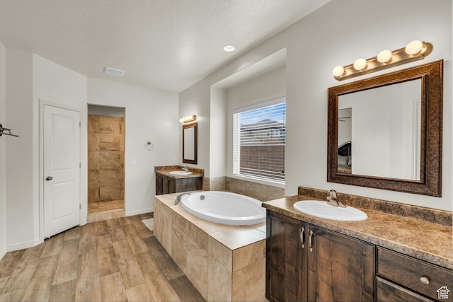 6116 S Rocky Talus Way, St George, UT 84790 - full bath featuring wood finished floors, two vanities, a sink, and a bath