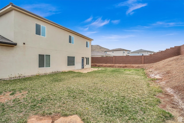 6116 S Rocky Talus Way, St George, UT 84790 - back of house with stucco siding, a fenced backyard, and a yard