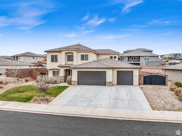 6116 S Rocky Talus Way, St George, UT 84790 - prairie-style house with stucco siding, a gate, fence, a garage, and stone siding
