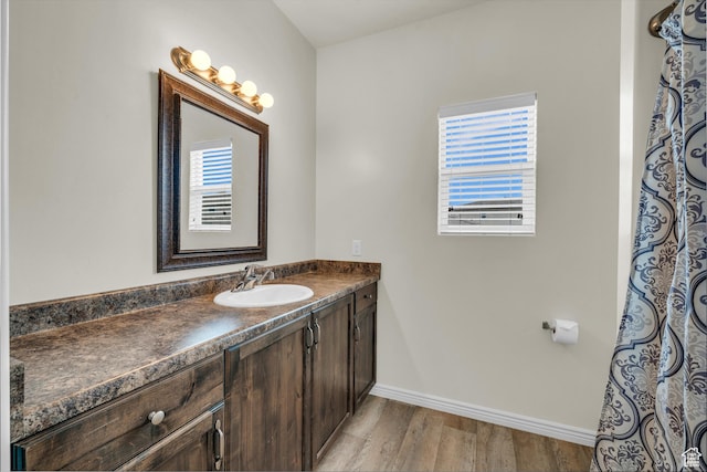 6116 S Rocky Talus Way, St George, UT 84790 - bathroom featuring wood finished floors, vanity, and baseboards