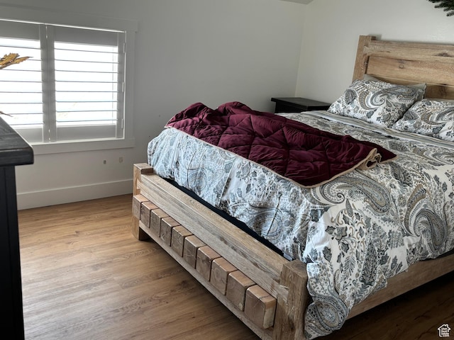 bedroom featuring baseboards and wood finished floors