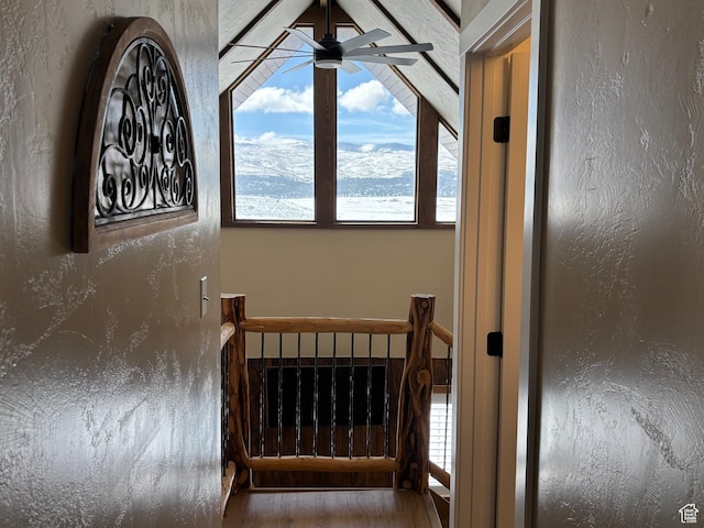 staircase featuring ceiling fan and a textured wall