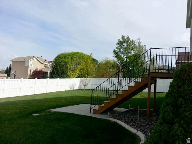 view of yard with stairs and fence