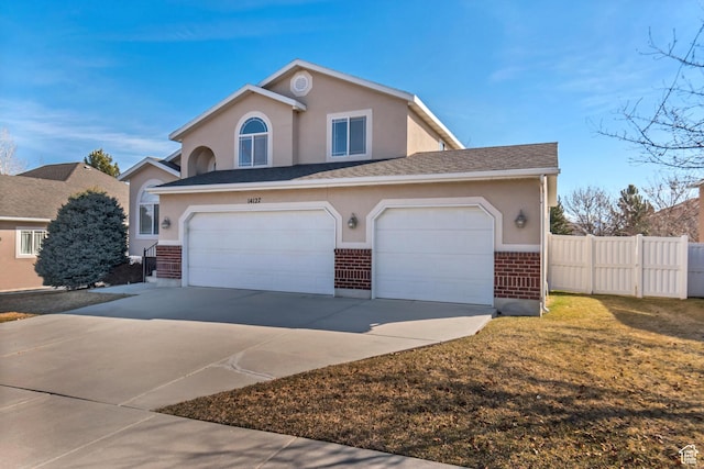view of front of house with brick siding, fence, concrete driveway, stucco siding, and an attached garage