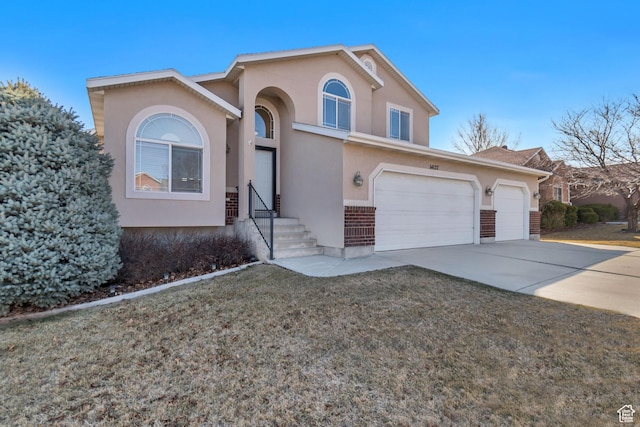 view of front facade with brick siding, stucco siding, concrete driveway, and a front lawn