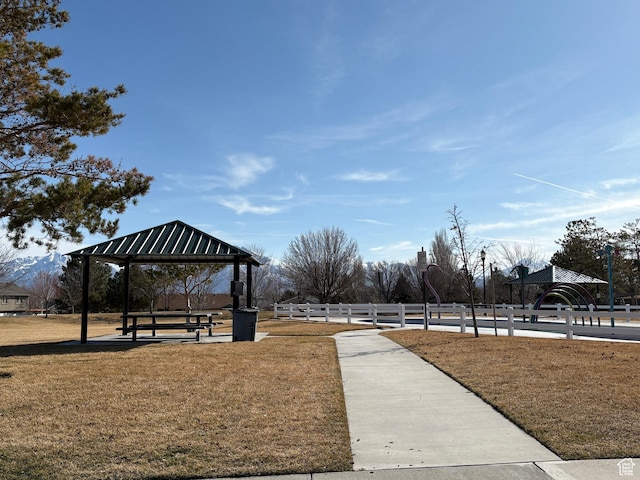 view of property's community with a gazebo, a yard, and fence