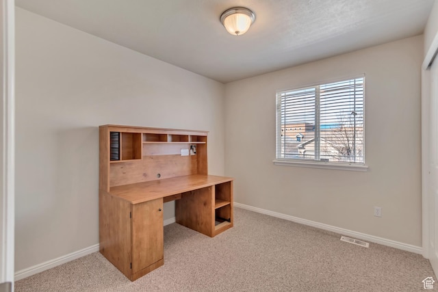 carpeted office with visible vents and baseboards