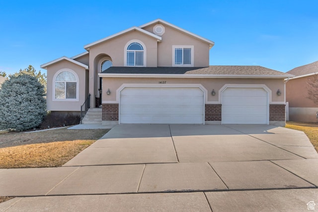 view of front of house with concrete driveway, brick siding, and stucco siding