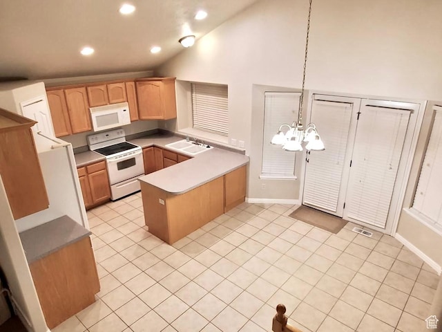 kitchen with white appliances, visible vents, a peninsula, a sink, and vaulted ceiling