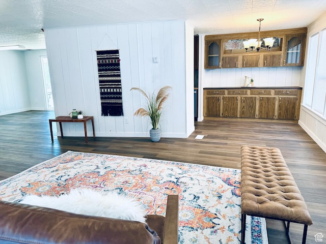 350 S 200 E, Ephraim, UT 84627 - interior space with baseboards, a textured ceiling, wood finished floors, and an inviting chandelier