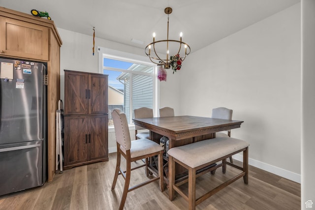 9444 N 4800 W, Elwood, UT 84337 - dining space featuring a chandelier, baseboards, and light wood-type flooring