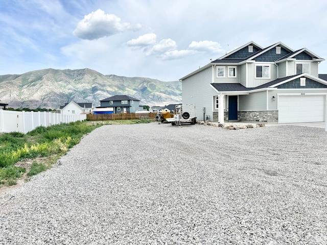 9444 N 4800 W, Elwood, UT 84337 - view of property exterior featuring gravel driveway, stone siding, and a mountain view