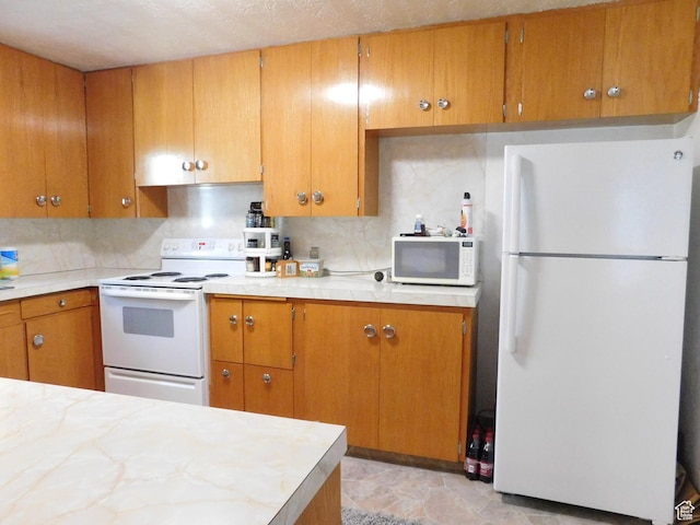 1660 W 700 S, Marriott Slaterville, UT 84404 - kitchen with light countertops, white appliances, brown cabinetry, and tasteful backsplash