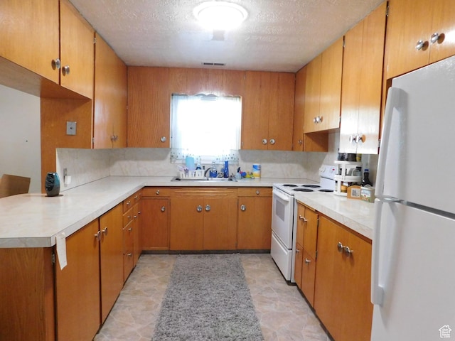 1660 W 700 S, Marriott Slaterville, UT 84404 - kitchen featuring light countertops, white appliances, and brown cabinets