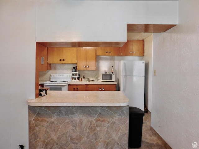 1660 W 700 S, Marriott Slaterville, UT 84404 - kitchen featuring white appliances, brown cabinetry, a peninsula, light countertops, and backsplash