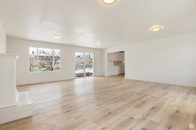 980 W 230 N, Orem, UT 84057 - unfurnished living room featuring light wood-style floors and baseboards