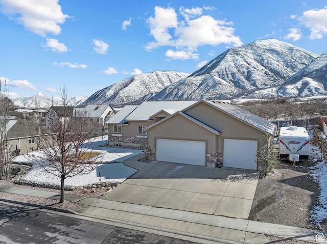 1137 S 925 E, Salem, UT 84653 - view of front facade with stucco siding, stone siding, a mountain view, concrete driveway, and a garage