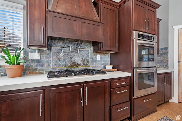 1137 S 925 E, Salem, UT 84653 - kitchen featuring light tile patterned flooring, light countertops, custom range hood, appliances with stainless steel finishes, and backsplash