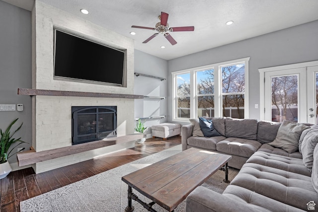 1137 S 925 E, Salem, UT 84653 - living room featuring recessed lighting, french doors, a large fireplace, and wood finished floors