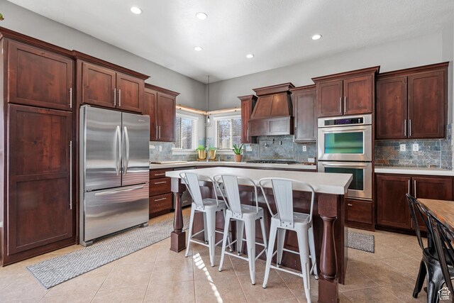 1137 S 925 E, Salem, UT 84653 - kitchen with a center island, premium range hood, a breakfast bar, light countertops, and appliances with stainless steel finishes