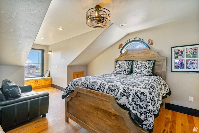 3250 W 1150 N, Roosevelt, UT 84066 - bedroom with an inviting chandelier, light wood-type flooring, baseboards, and vaulted ceiling
