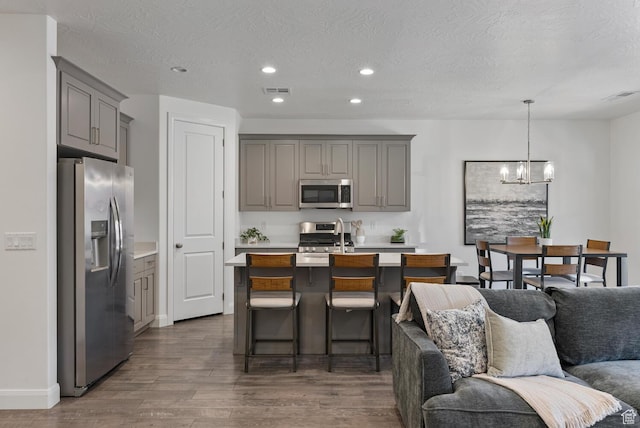 1392 N Marfil Way, Washington, UT 84780 - kitchen with visible vents, open floor plan, light countertops, gray cabinets, and appliances with stainless steel finishes