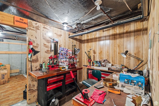 below grade area featuring a workshop area and wooden walls