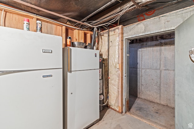 unfinished basement featuring freestanding refrigerator
