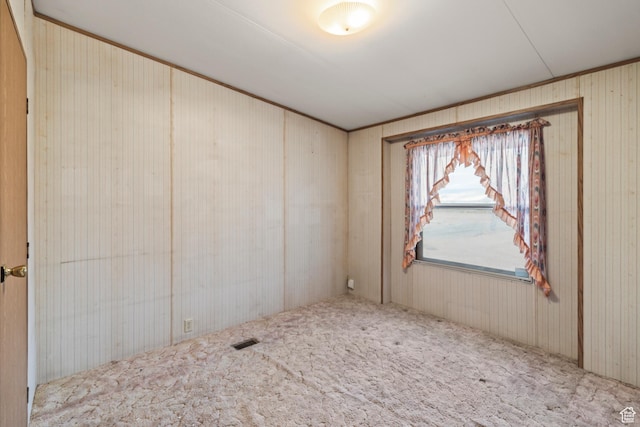 unfurnished room with visible vents and carpet floors