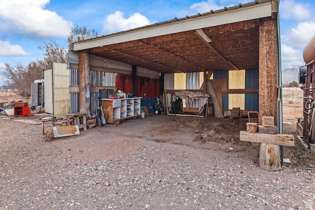 rear view of house with metal roof and an outbuilding