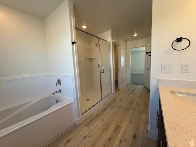 3269 S 1000 W, Nibley, UT 84321 - bathroom featuring a bath, a stall shower, vanity, and wood finished floors