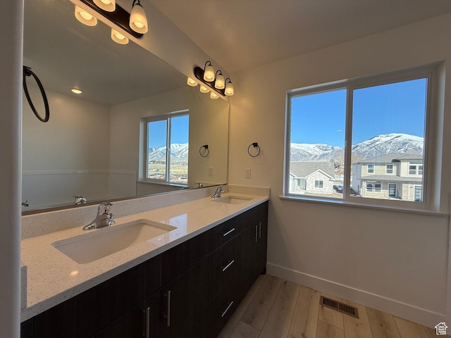 3269 S 1000 W, Nibley, UT 84321 - bathroom featuring visible vents, a mountain view, baseboards, and a sink