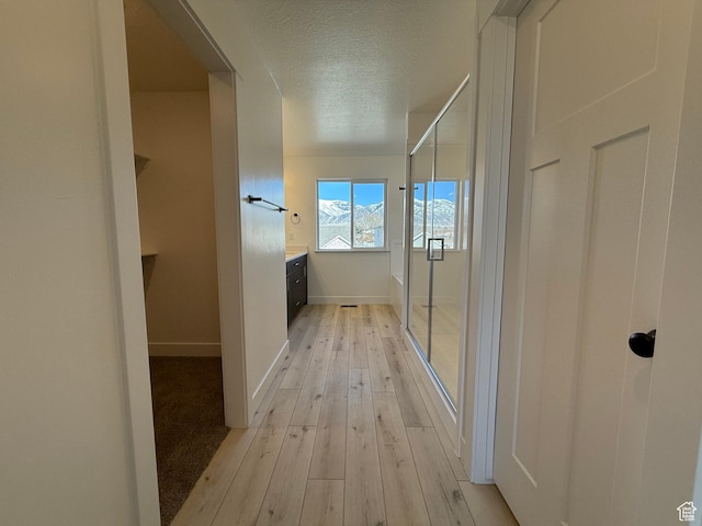 3269 S 1000 W, Nibley, UT 84321 - hallway with light wood-type flooring, baseboards, and a textured ceiling