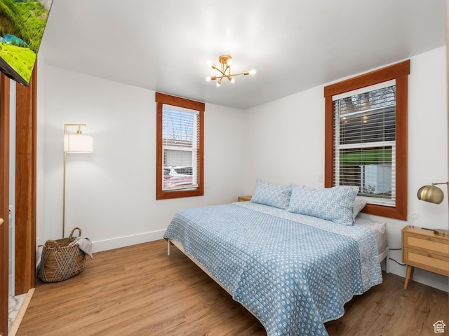 330 W 100 S, Springville, UT 84663 - bedroom featuring baseboards, an inviting chandelier, and wood finished floors