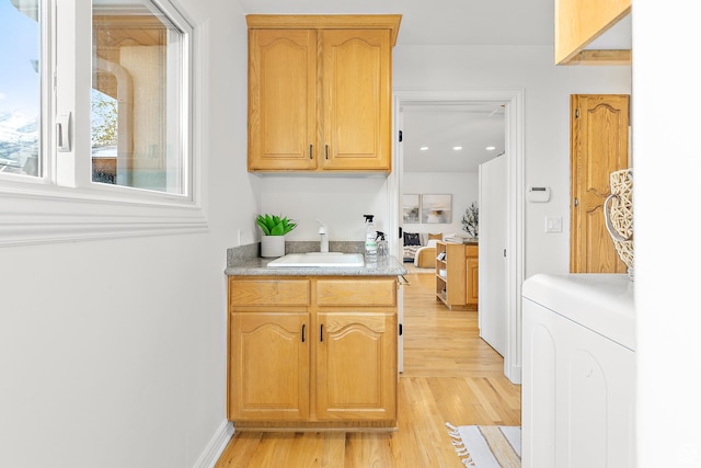539 E Normandy Dr, Provo, UT 84604 - kitchen with light countertops, light wood-style flooring, baseboards, a sink, and washer / dryer