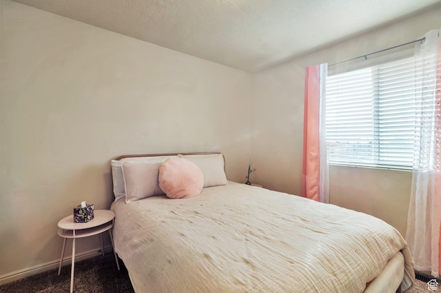 carpeted bedroom with baseboards