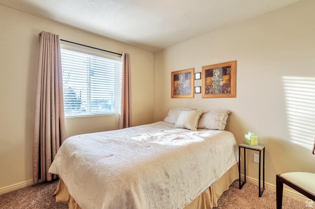 carpeted bedroom featuring baseboards