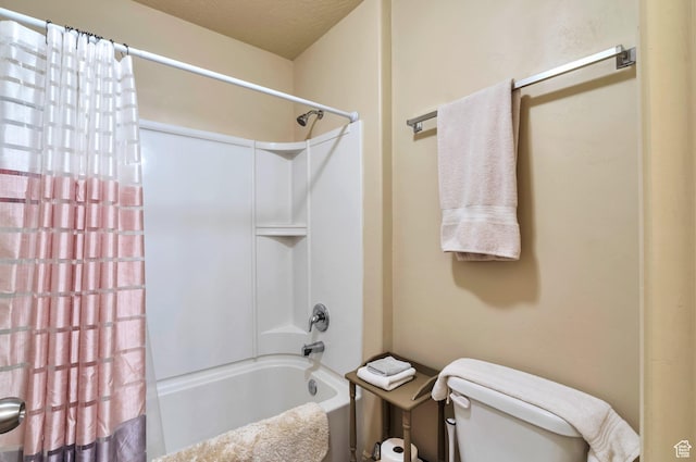 full bathroom with toilet, shower / bath combo, and a textured ceiling
