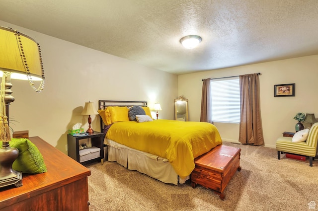 carpeted bedroom featuring baseboards and a textured ceiling