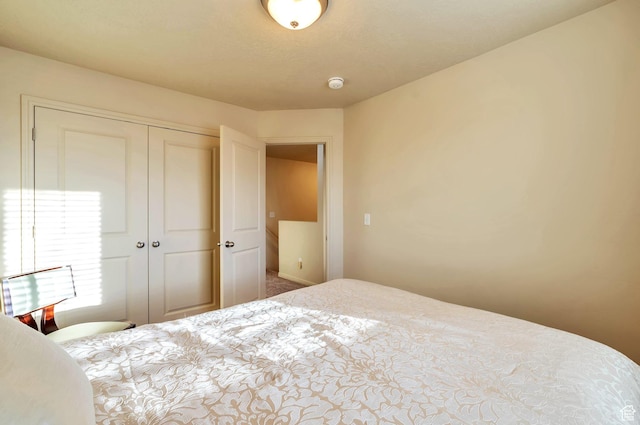 carpeted bedroom featuring a closet