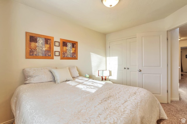 bedroom with light colored carpet and a closet