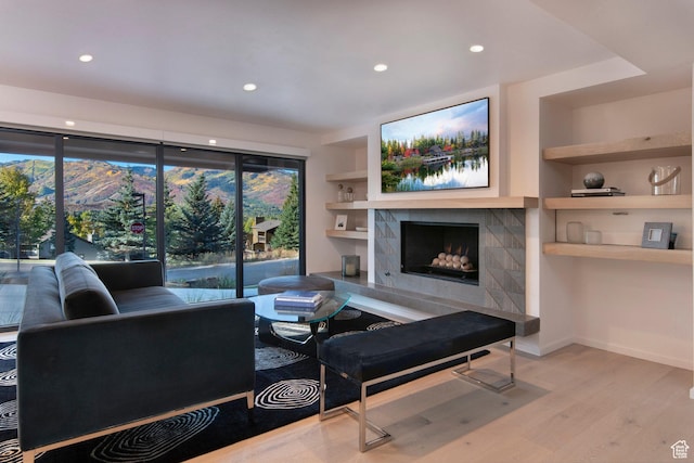 2559 Lupine Ln, Park City, UT 84060 - living room featuring wood finished floors, a tiled fireplace, recessed lighting, and built in shelves