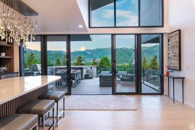 2559 Lupine Ln, Park City, UT 84060 - doorway with a wall of windows, wood finished floors, a mountain view, a chandelier, and recessed lighting