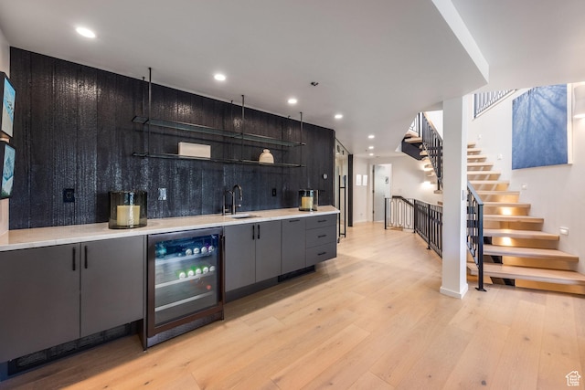 2559 Lupine Ln, Park City, UT 84060 - indoor wet bar featuring beverage cooler, light wood finished floors, stairway, and recessed lighting