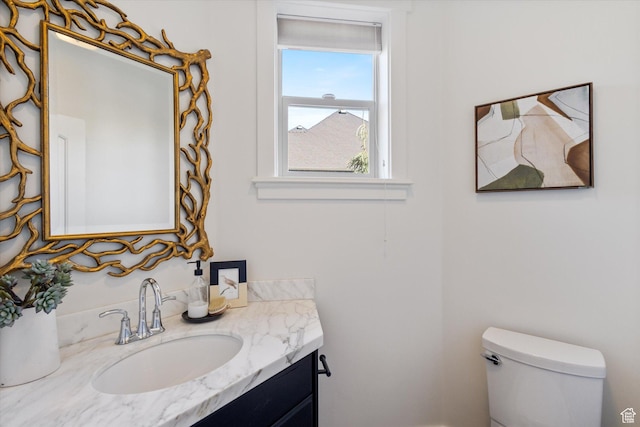 bathroom featuring toilet and vanity