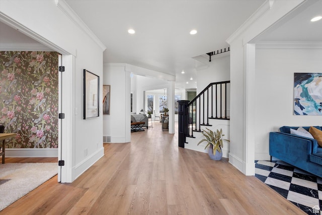 foyer entrance with light wood-type flooring, recessed lighting, stairway, and crown molding