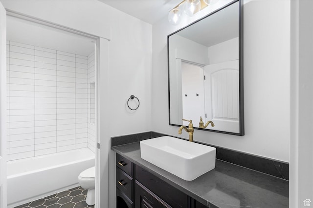 full bath with shower / bath combination, vanity, tile patterned flooring, and toilet