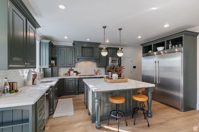 kitchen with crown molding, open shelves, a sink, built in appliances, and a kitchen island