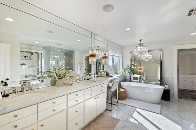 bathroom featuring visible vents, a stall shower, a notable chandelier, and a sink